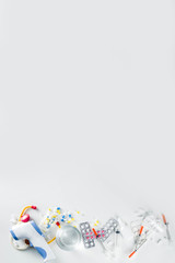 Pharmaceutical medicine pills concept, Assorted various pills, tablets and capsules with medical syringes, thermometer and water glass, copy space mockup, flatlay