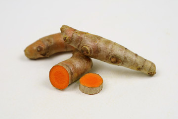 Fresh turmeric, isolated on a white background, is an ingredient in food. Turmeric helps treat high...