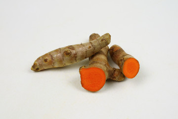 Fresh turmeric, isolated on a white background, is an ingredient in food. Turmeric helps treat high blood pressure.