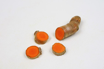 Fresh turmeric, isolated on a white background, is an ingredient in food. Turmeric helps treat high...