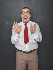 Funny Angry screaming teacher or business man on blackboard