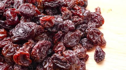 Close up of heap of dried raisins on the table.