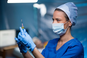 Doctor holding syringe in hospital, coronavirus concept.