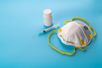 Medical masks, vaccines, medicines on white background