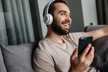 Positive man listening music with headphones