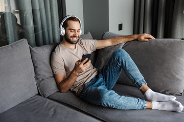 Positive man listening music with headphones