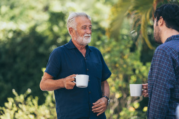 Old father and son, Morning coffee in a garden