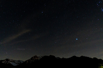 Obraz na płótnie Canvas the stars and the night sky seen from the italian alps, during a fantastic winter night, near the town of Branzi, Italy - February 2020.