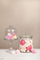 Marshmallows and meringues on a wooden table.