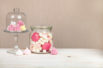 Marshmallows and meringues on a wooden table.
