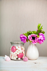 Marshmallows in a jar and a bouquet of flowers