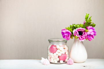 Marshmallows in a jar and a bouquet of flowers