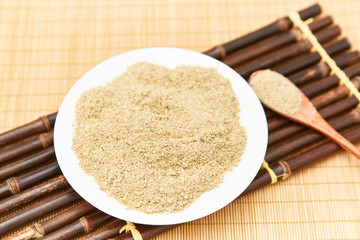 A pile of rice bran in a bamboo basket