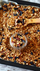 Selective focus. Fresh homemade granola. Healthy breakfast or snack. Cooking granola.