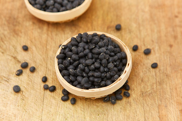 A pile of black beans in the bamboo basket