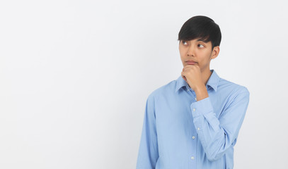 Young handsome asian business man thinking an idea while looking up isolated on white background.