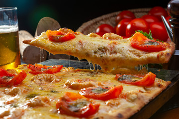 Pizza artesanal de queijo e tomates no formato quadrado, pizza cortada