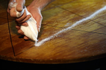 Men's hands set candles on the pentagram symbol