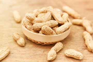 A pile of peanuts in a bamboo basket