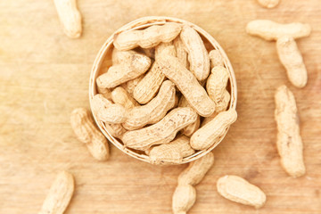 A pile of peanuts in a bamboo basket