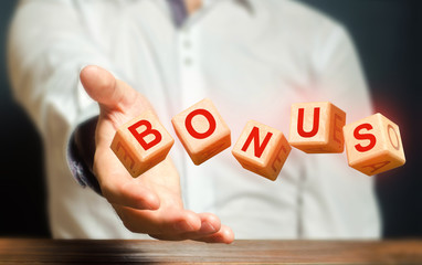 Cubes thrown by a man make word BONUS. Receive bonuses, rewards and preferences. Salary increase,...