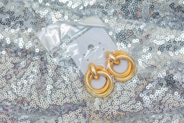 Modern asymmetrical golden earrings with layered rings