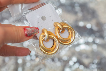 Modern asymmetrical golden earrings with layered rings