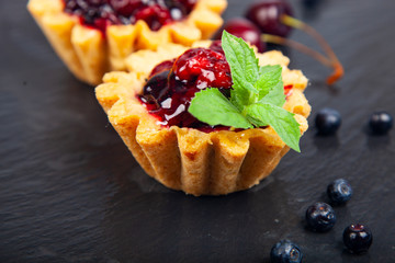 Small berry cake and ripe berries
