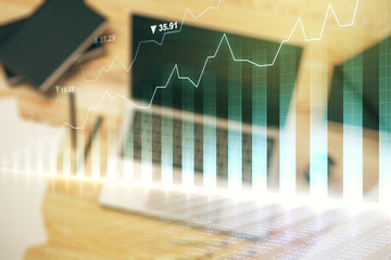 Multi exposure of abstract financial graph on laptop background, financial and trading concept