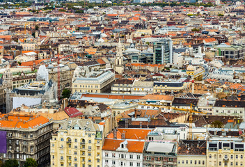 Obraz premium Historical downtown of Budapest, Hungary, Europe from above, aerial view. Rooftop view with old town buildings, church towers, rooftops, construction cranes. European capital city Budapest skyline.