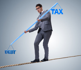 Businessman balancing between debt and tax