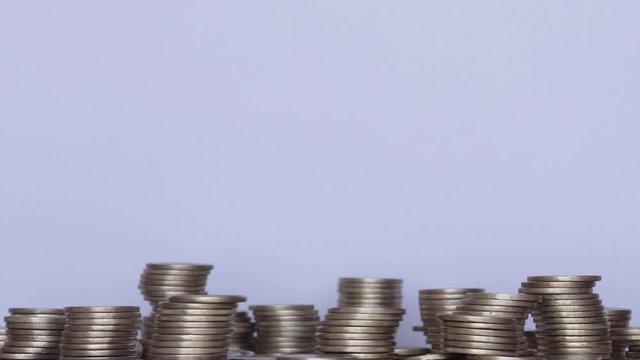 Pile of golden coin in movement over white background