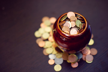 The concept of saving money predefined by saving coins for a growing business division.