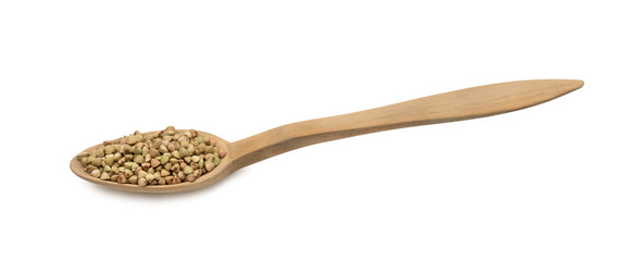 Green buckwheat on a wood spoon seen directly from above and isolated on white background