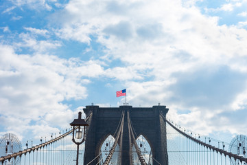 Fototapeta premium Arches on the Brooklyn Bridge with an American Flag in New York City