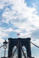 Fototapeta premium Arches on the Brooklyn Bridge with an American Flag in New York City