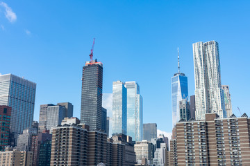 Plakat Lower Manhattan New York City Skyline Scene with Modern Skyscrapers on a Clear Blue Day