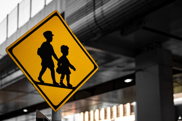 Children's signboard across the road with cityscape backgrounds