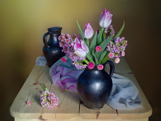 Still life of different spring flowers in a vase.