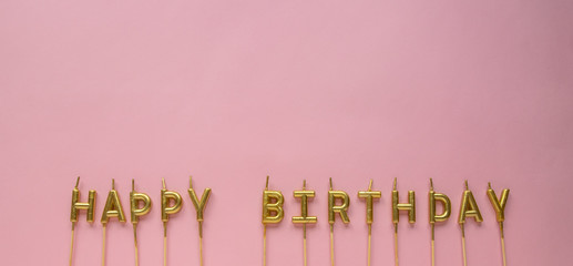 Happy Birthday golden candles on blue background. Golden birthday candles. Top view