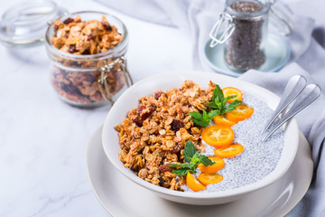 Chia pudding bowl with homemade granola and kumquats for breakfast