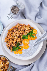 Chia pudding bowl with homemade granola and kumquats for breakfast