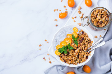 Chia pudding bowl with homemade granola and kumquats for breakfast