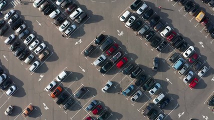 Top view car Parking on parking place near Shopping center. Aerial view from Drone lot of Cars Moving and standing on City Mall parking.