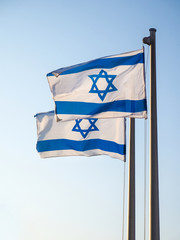 Two national flags of Israel outdoors against the blue sky
