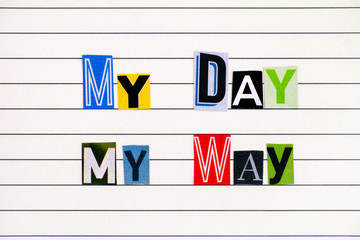 Obraz premium Phrase My Day My Way made from letters cutting from magazines on lined paper.
