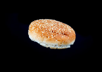 sesame seeds hamburger bread on a black background