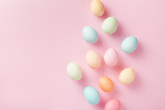 Pastel Easter Eggs On Pink Background Top View. Flat Lay Style.