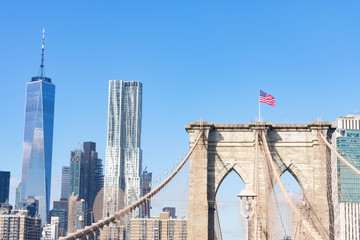Arches on the Brooklyn Bridge with an American Flag and the Lower Manhattan New York City Skyline