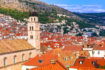 Fototapeta premium Dubrovnik Old Town: Close-up of Medieval Tower with Round Dome, Ancient City Walls and Traditional Red Tiled Roofs, Pearl of Adriatic Coast, UNESCO Heritage Site Dalmatia Croatia 4K High Resolution